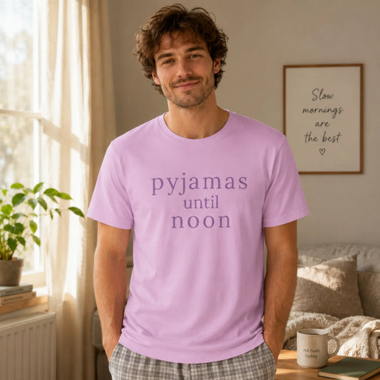 Male model wearing a lilac Pyjamas Until Noon T-shirt in a calm cosy morning setting, styled as relaxed everyday loungewear.