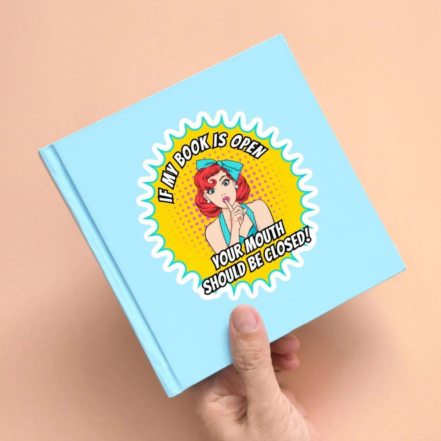 Sassy book lover waterproof vinyl sticker on a small blue book 