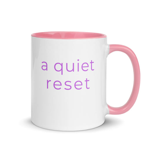 Minimalist ceramic coffee mug with pink handle and the phrase “a quiet reset”, designed for calm moments and everyday relaxation.
