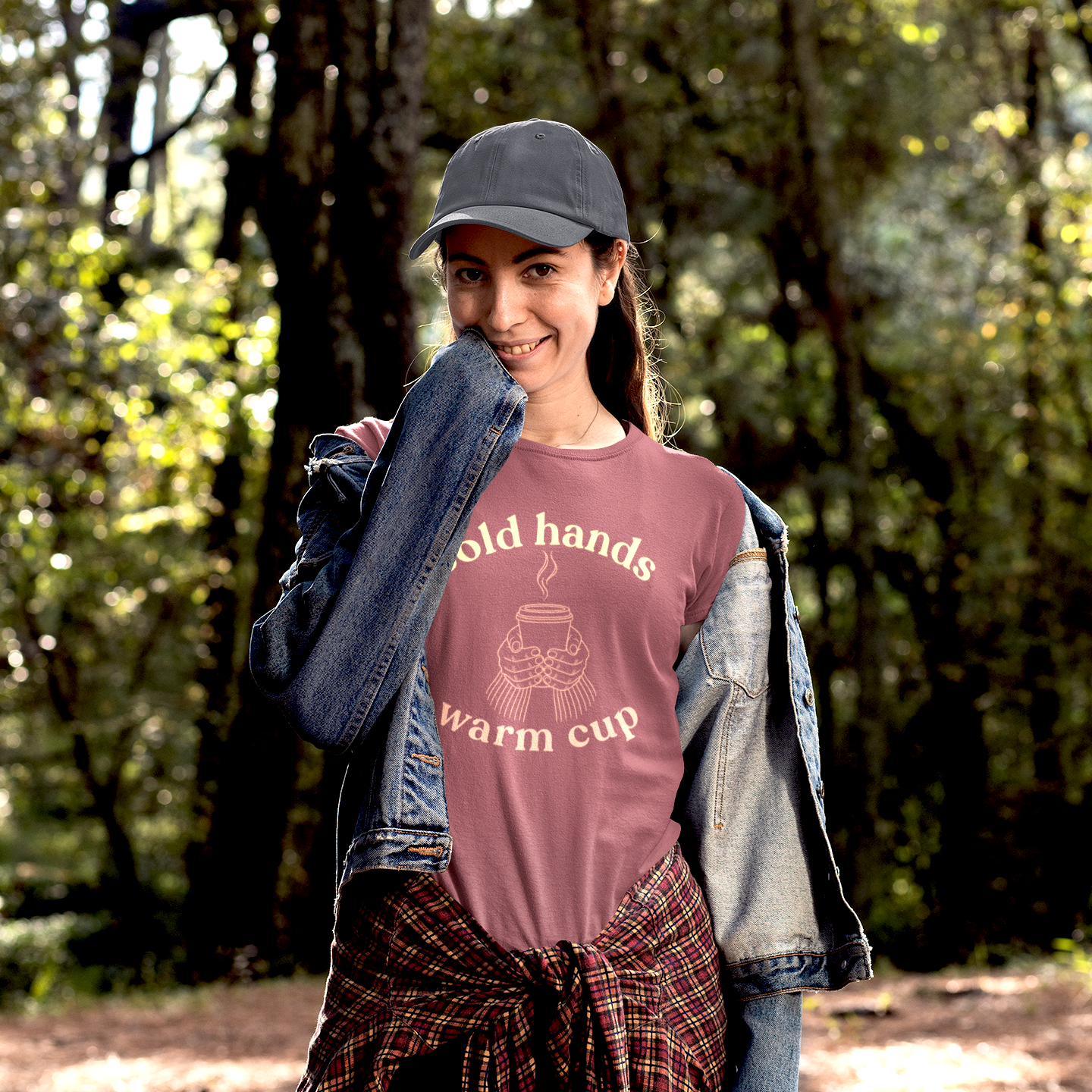 Woman wearing Brick Cold Hands Warm Cup cozy fall T-Shirt layered with denim jacket outdoors