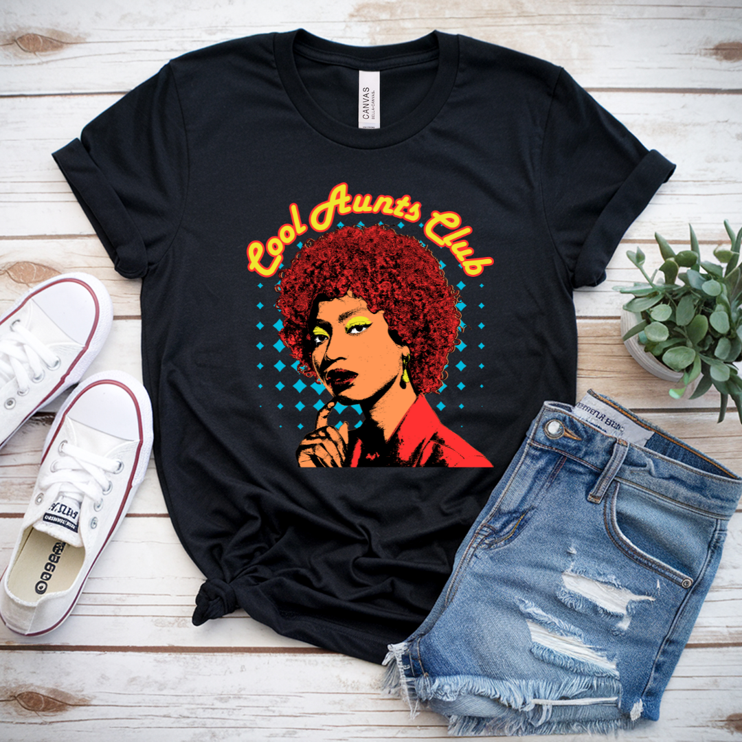 Flat lay Cool Aunts Club t-shirt with jeans and accessories