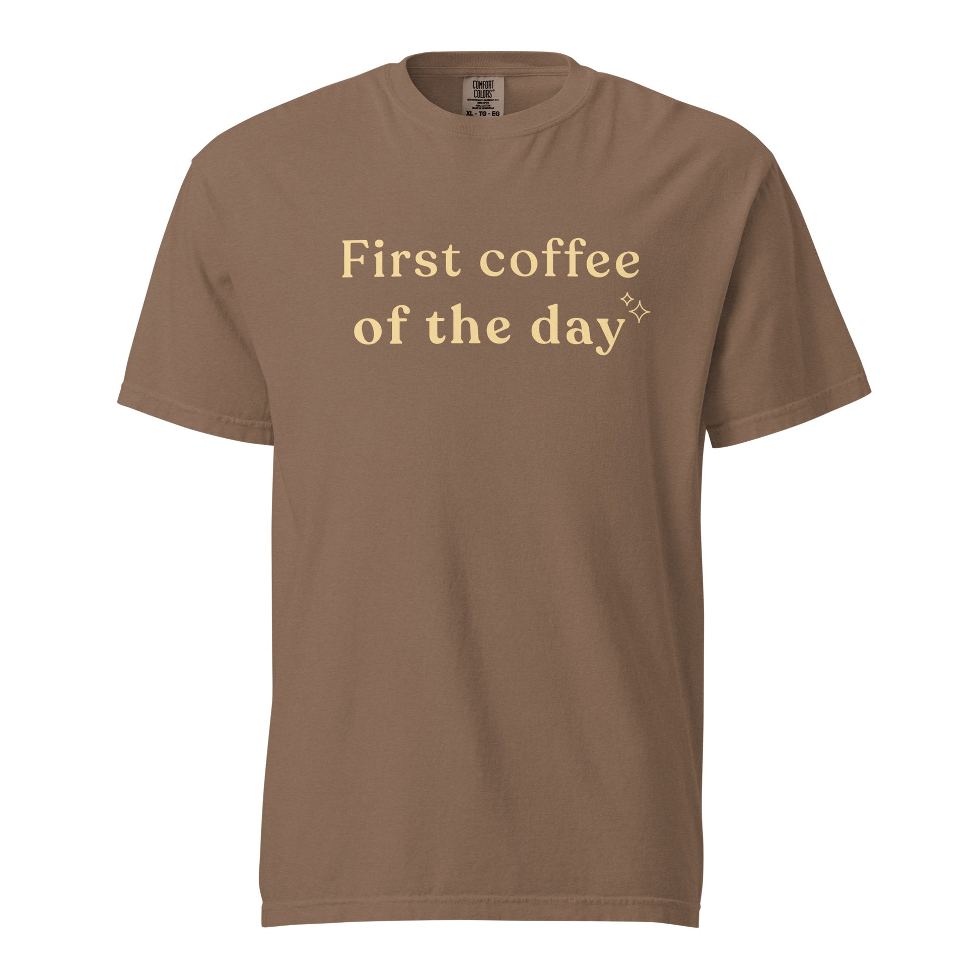 Espresso brown Comfort Colors T-shirt featuring “First coffee of the day” graphic in soft cream lettering