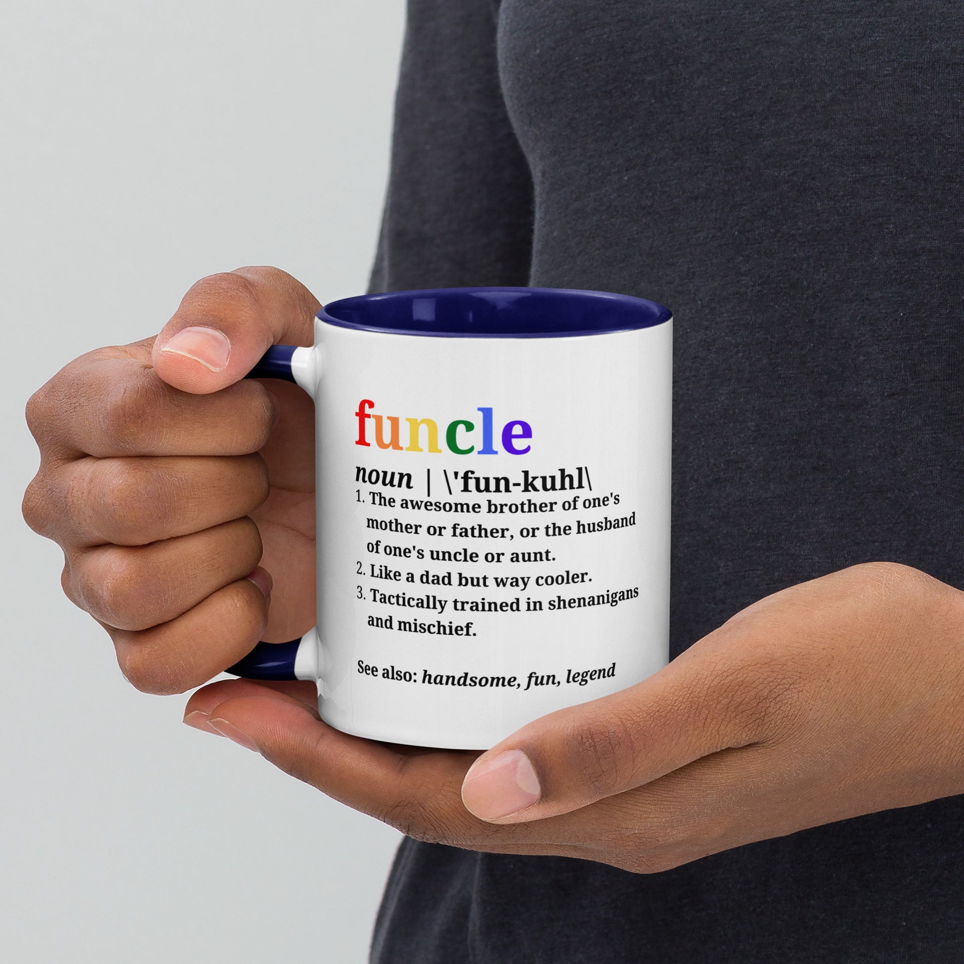 Hands holding Funcle ceramic mug with navy interior visible