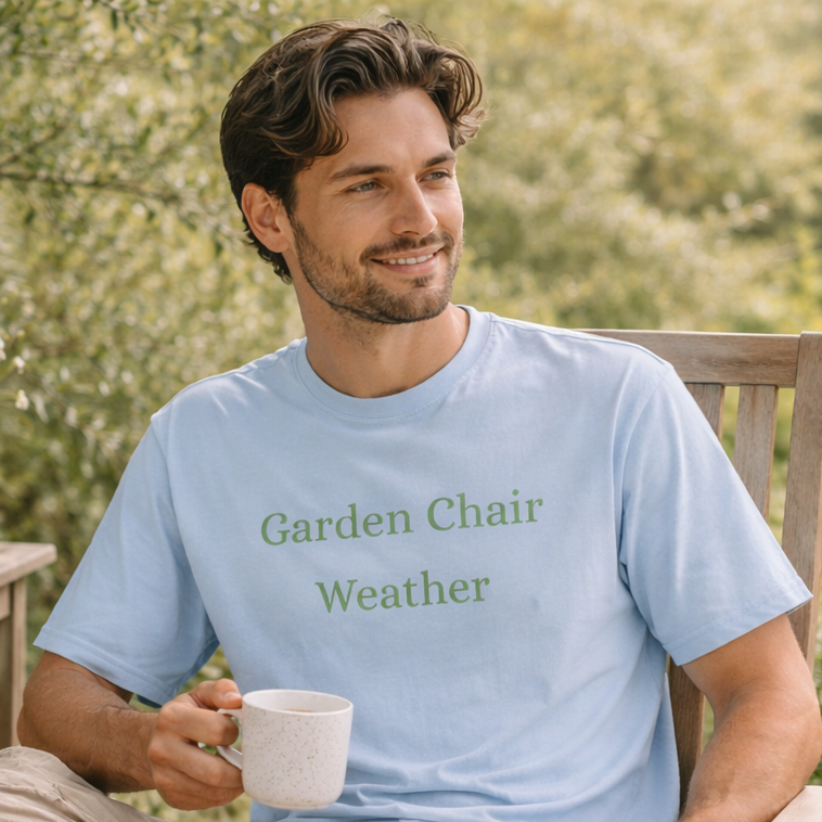 Man sitting on a wooden garden chair wearing chambray Garden Chair Weather T-shirt