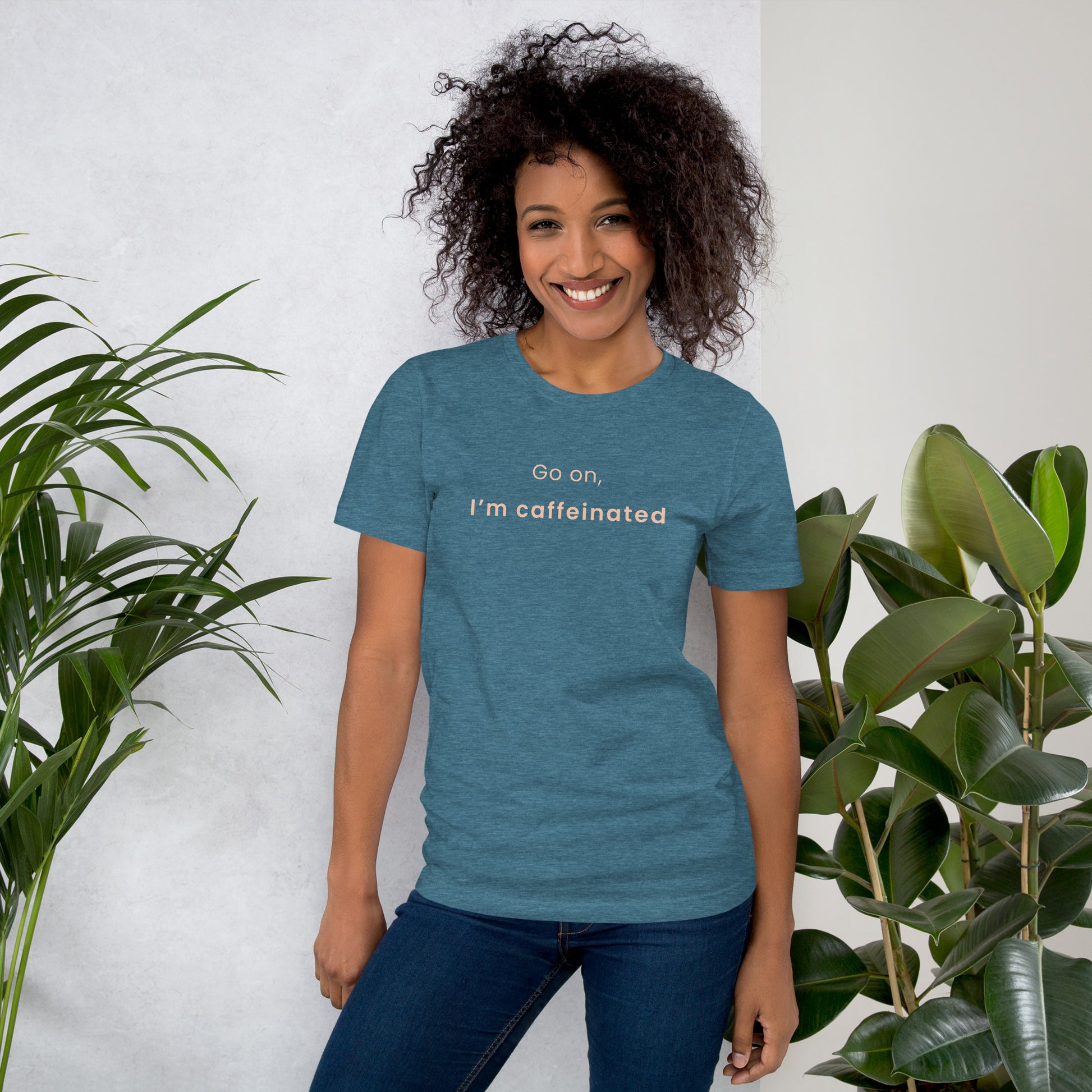 Woman wearing deep teal “Go on, I’m caffeinated” coffee T-shirt