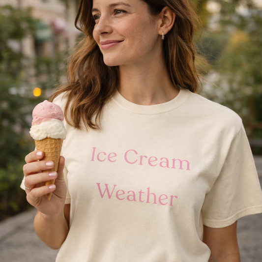 Ice Cream Weather Comfort Colors T-shirt worn by woman holding strawberry and vanilla ice cream cone in warm outdoor setting