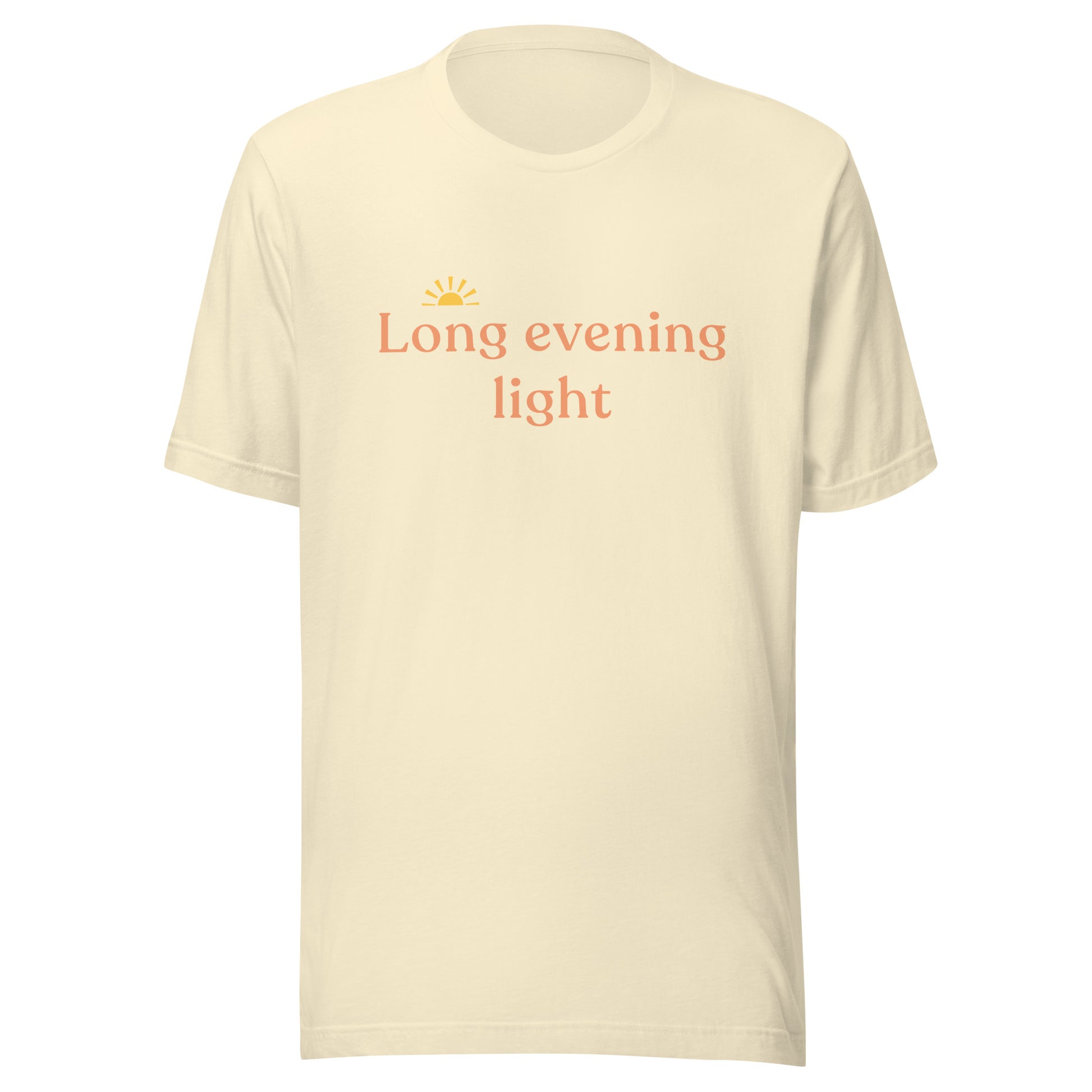 Long Evening Light T-Shirt in natural cream with warm coral text and a small golden sun graphic on the front.