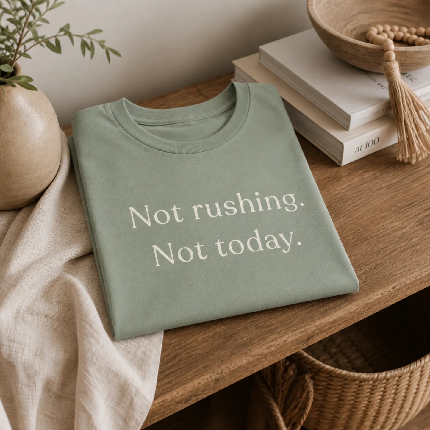Folded Not Rushing Not Today T-Shirt styled on a calm shelf with soft neutral home decor.