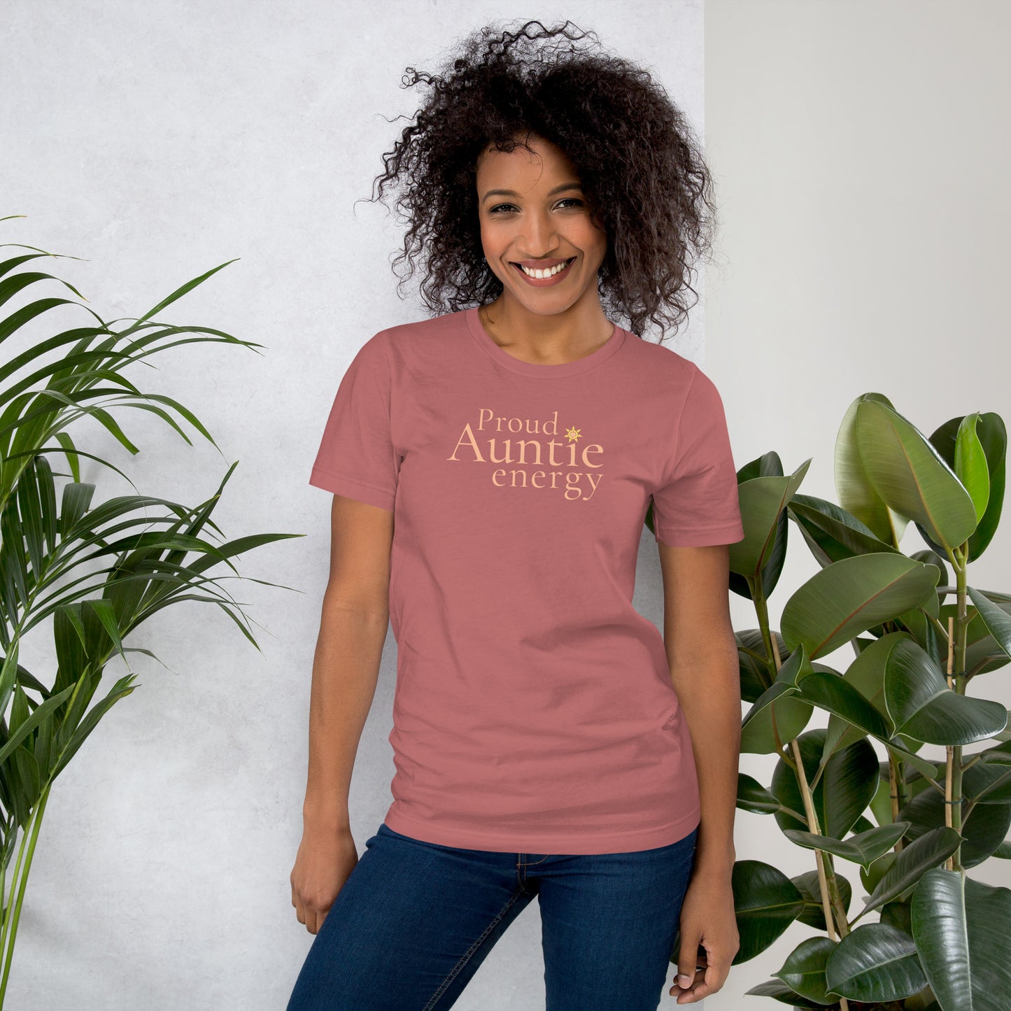 Woman wearing Proud Auntie Energy mauve T-shirt styled casually with jeans