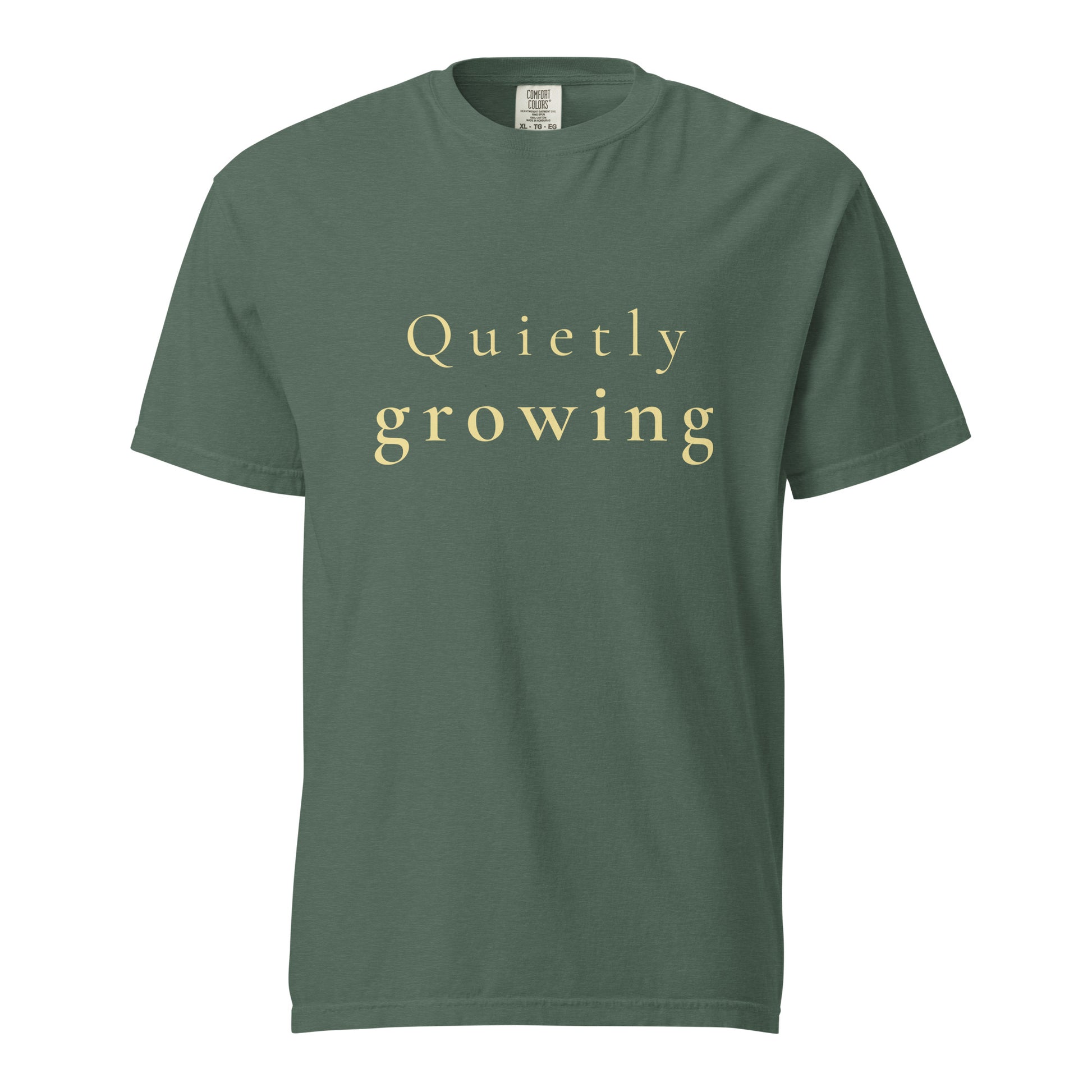 blue spruce Comfort Colors T-shirt with “Quietly growing” text shown flat, minimal product image
