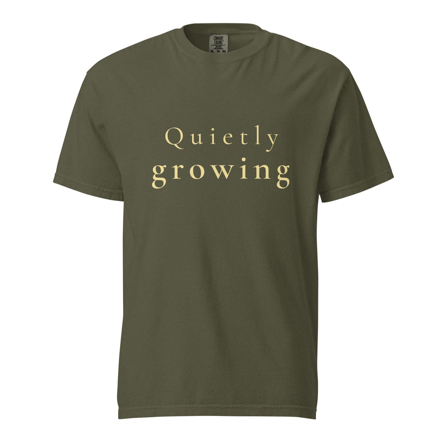 sage green Comfort Colors T-shirt with “Quietly growing” text shown flat, minimal product image