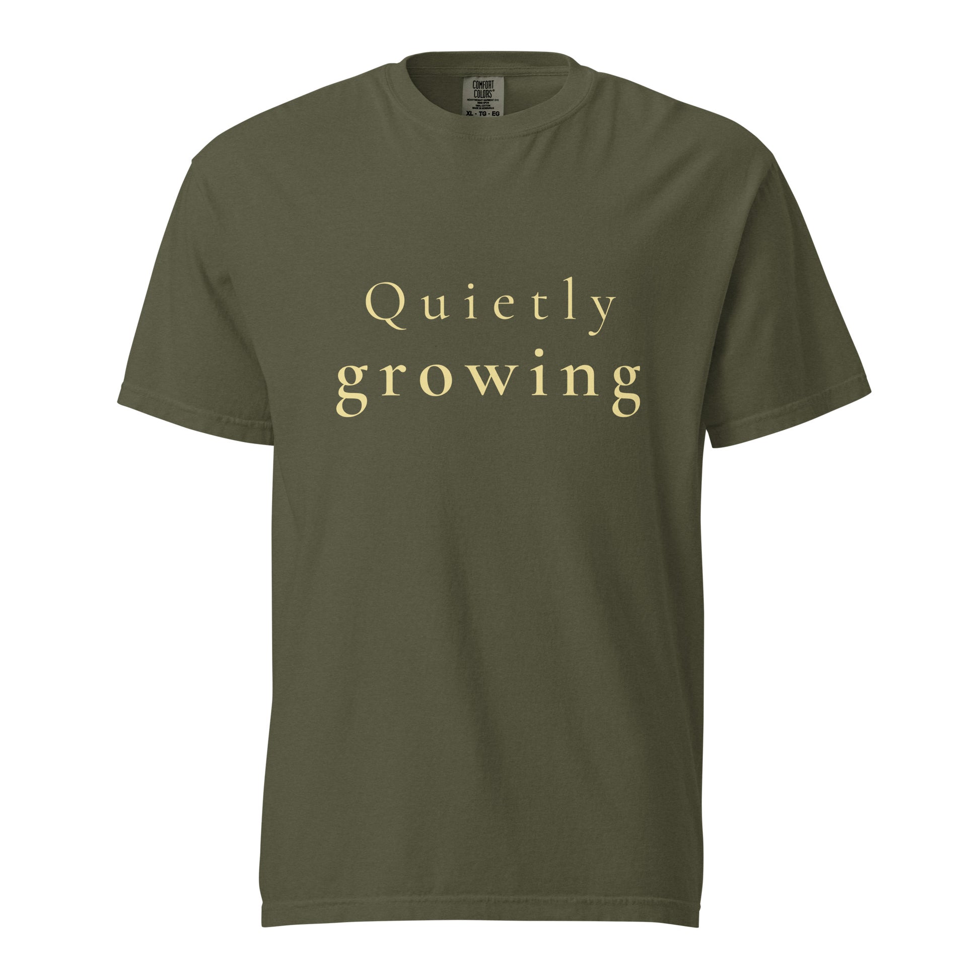 sage green Comfort Colors T-shirt with “Quietly growing” text shown flat, minimal product image