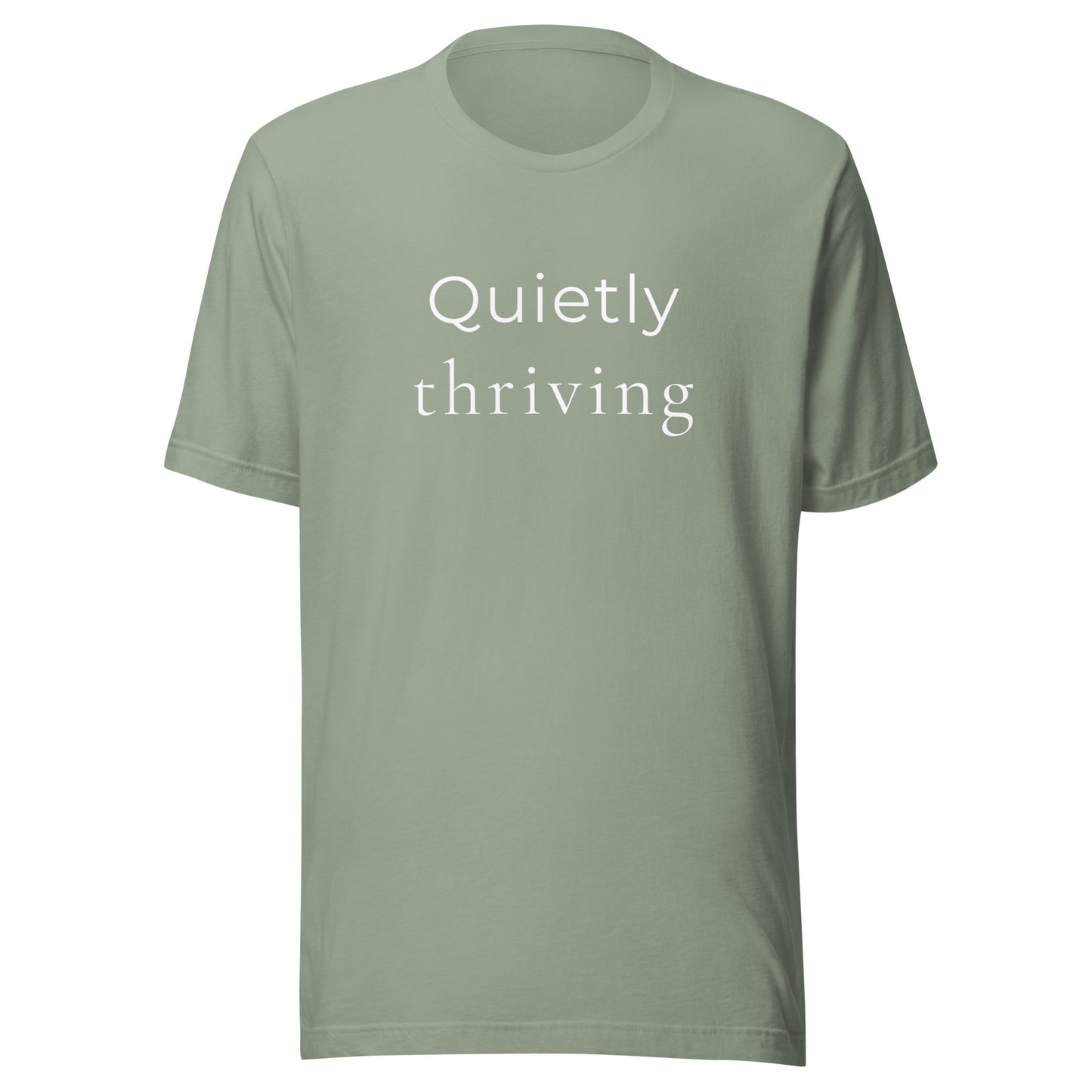 “Quietly Thriving” minimalist graphic T-shirt in sage green on soft unisex Bella+Canvas tee