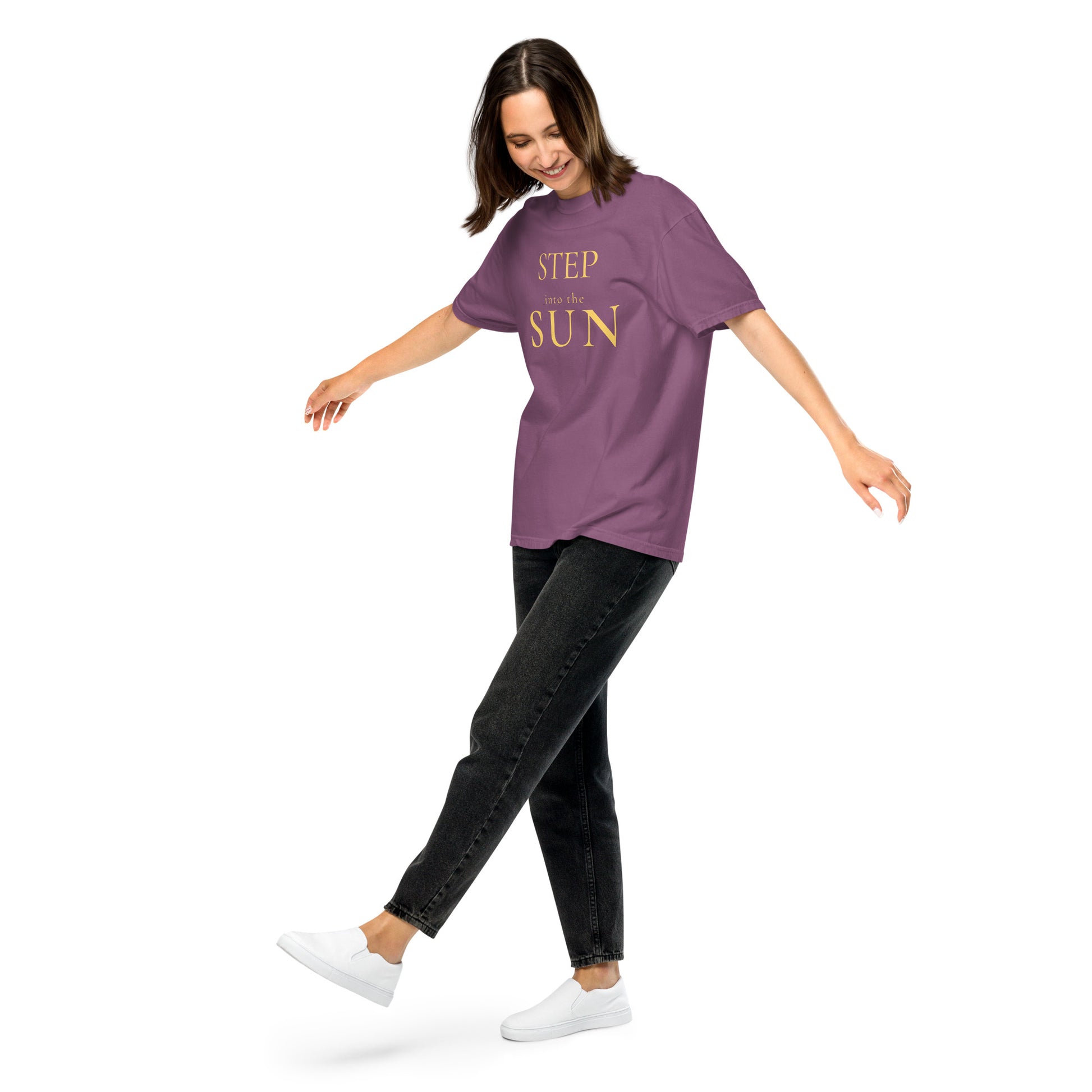 Woman in Berry Step Into the Sun graphic tee styled casually with jeans and trainers.