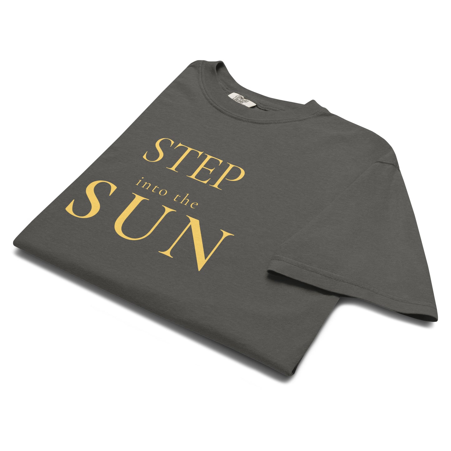 Folded Pepper Comfort Colors Step Into the Sun T-shirt showing gold typography detail.