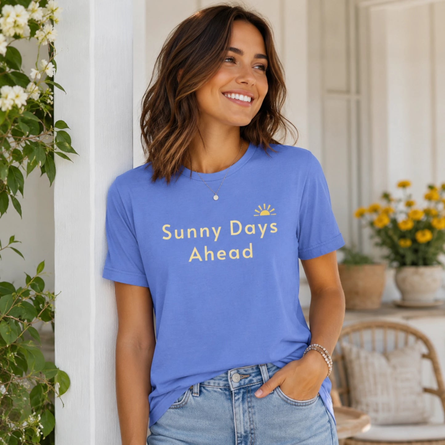 Female model wearing a Heather Columbia Blue Sunny Days Ahead T-shirt in a bright, airy outdoor lifestyle setting.