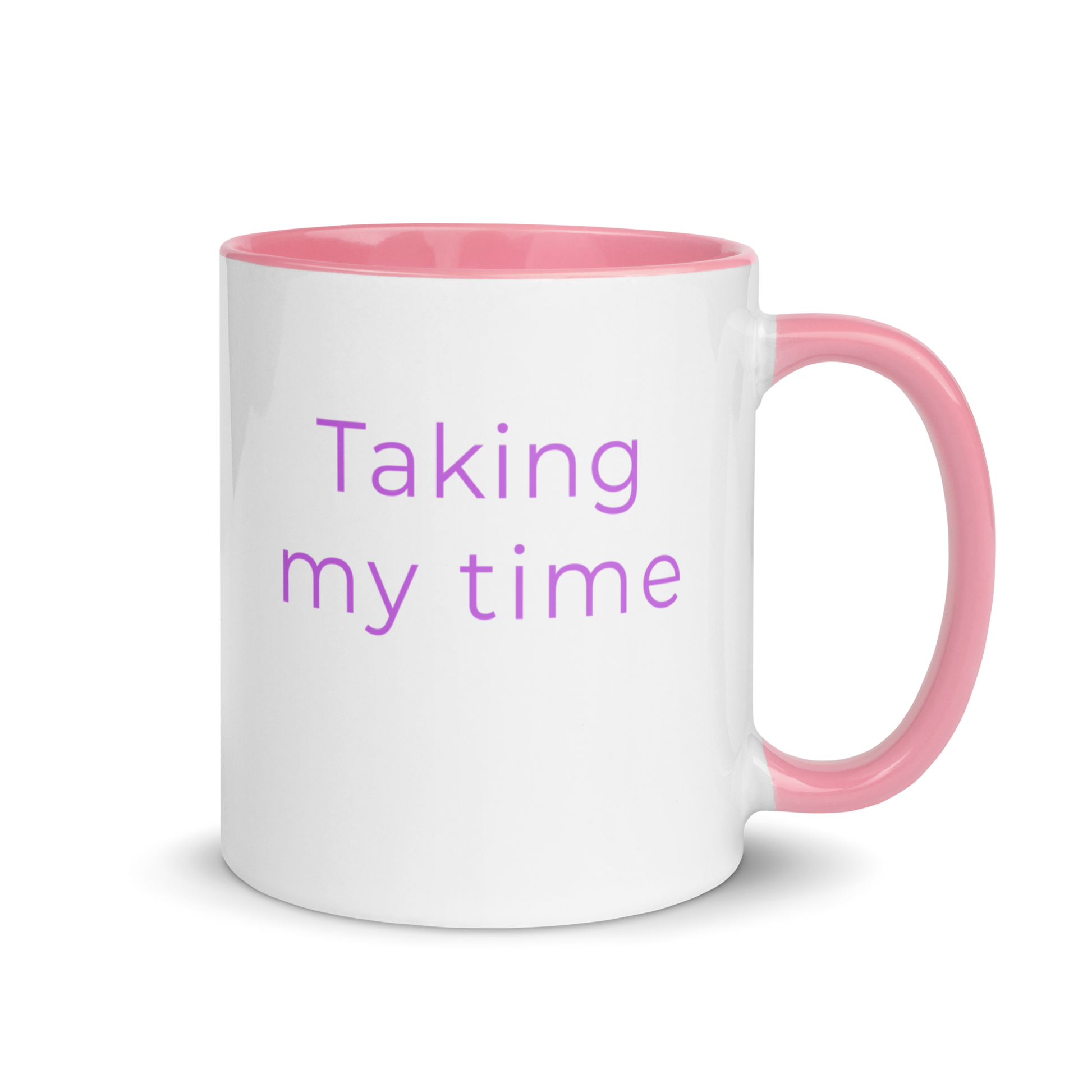 Minimalist ceramic coffee mug with pink handle and the phrase “taking my time”, designed for slow living and calm everyday moments.