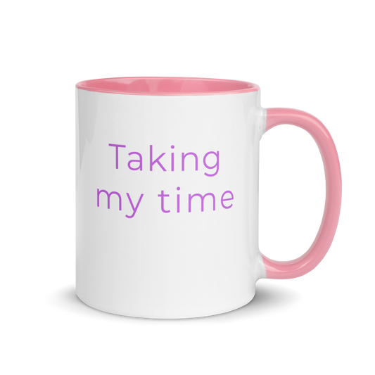 Minimalist ceramic coffee mug with pink handle and the phrase “taking my time”, designed for slow living and calm everyday moments.