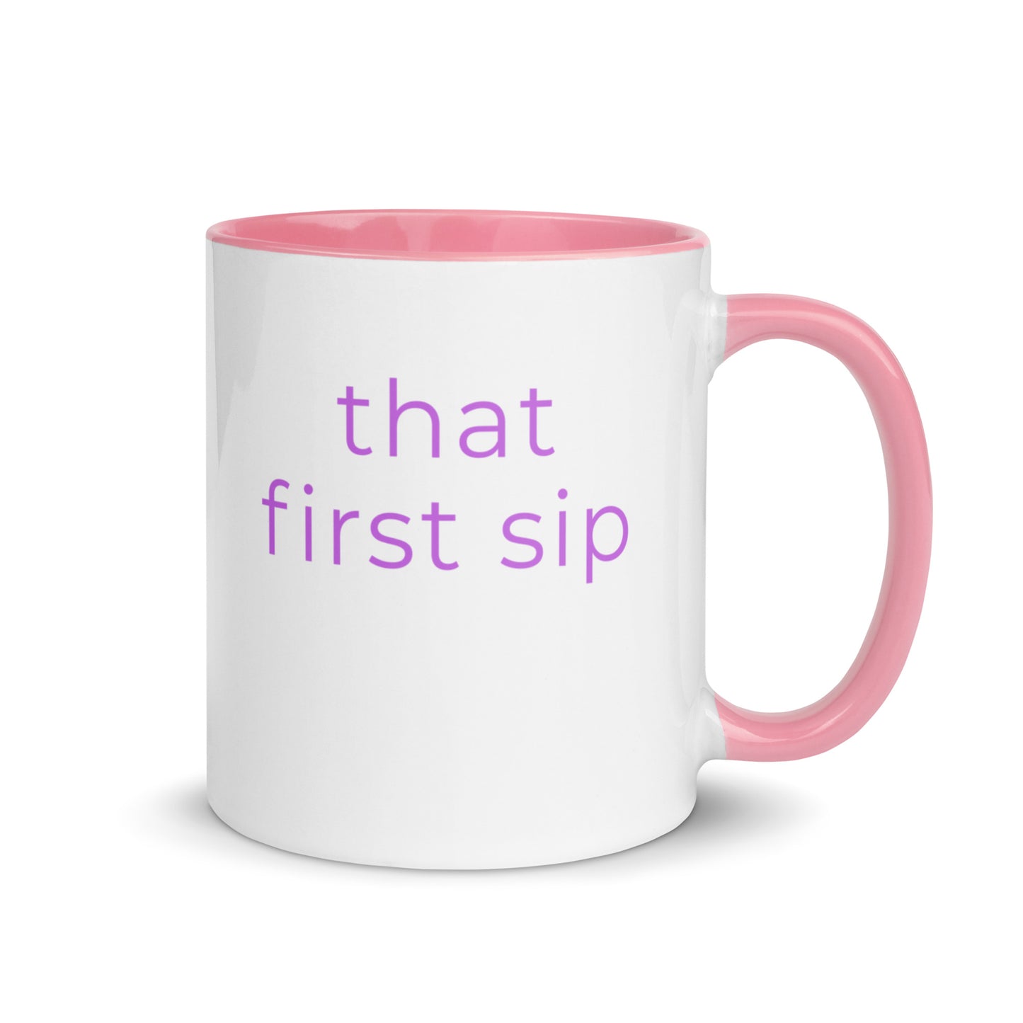 Minimalist ceramic coffee mug with pink handle and the phrase “that first sip”, designed for cosy mornings and comforting everyday rituals.