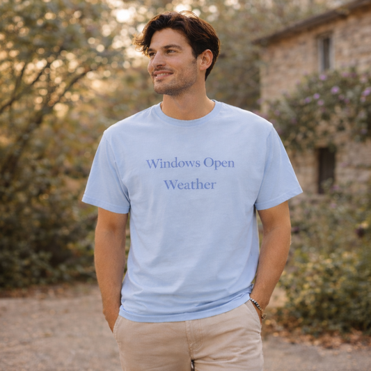 Man wearing chambray blue Windows Open Weather Comfort Colors T-shirt outdoors on a sunny spring day lifestyle mockup